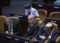 Israel's Prime Minister Benjamin Netanyahu, sits in a tan leather chair surrounded by ministers from the government attends a session of the Knesset, Israel's parliament, in Jerusalem.