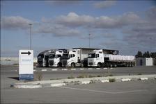 Trucks loaded with humanitarian aid for the Gaza Strip are seen parked in a row in an empty lot