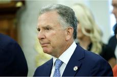 Steve Witkoff wearing a navy blue suit, white dress shirt, and blue tie.