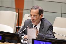 Rashid Khalidi speaking into a microphone while wearing a dark suit.