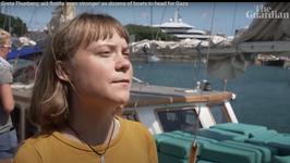 Greta Thunberg standing on a dock next to a boat speaking to a reporter