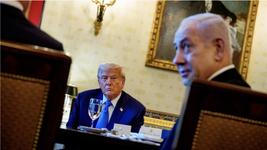 President Donald Trump looks across a dining table at Prime Minister Benjamin Netanyahu