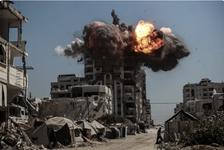 Black smoke and flames rise from the top of a tall tower