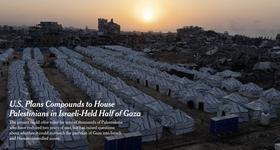 Rows of white tents with black stripes sit on a plot of land surrounded by damaged buildings and piles of rubble