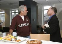 Jeffrey Epstein with Alan Dershowitz stand in front of platters of food
