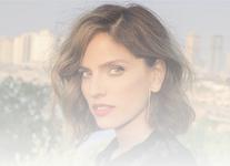 Actress, Noa Tisby, poses in front of a cityscape