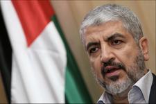 Khaled Meshaal pictured near a Palestinian flag