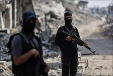 Armed Hamas members are seen guarding an area surrounded by rubble
