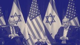 A monochrome photo of Biden and Netanyahu seated next to each other in leather arm chairs in front of a row of US and Israeli flags